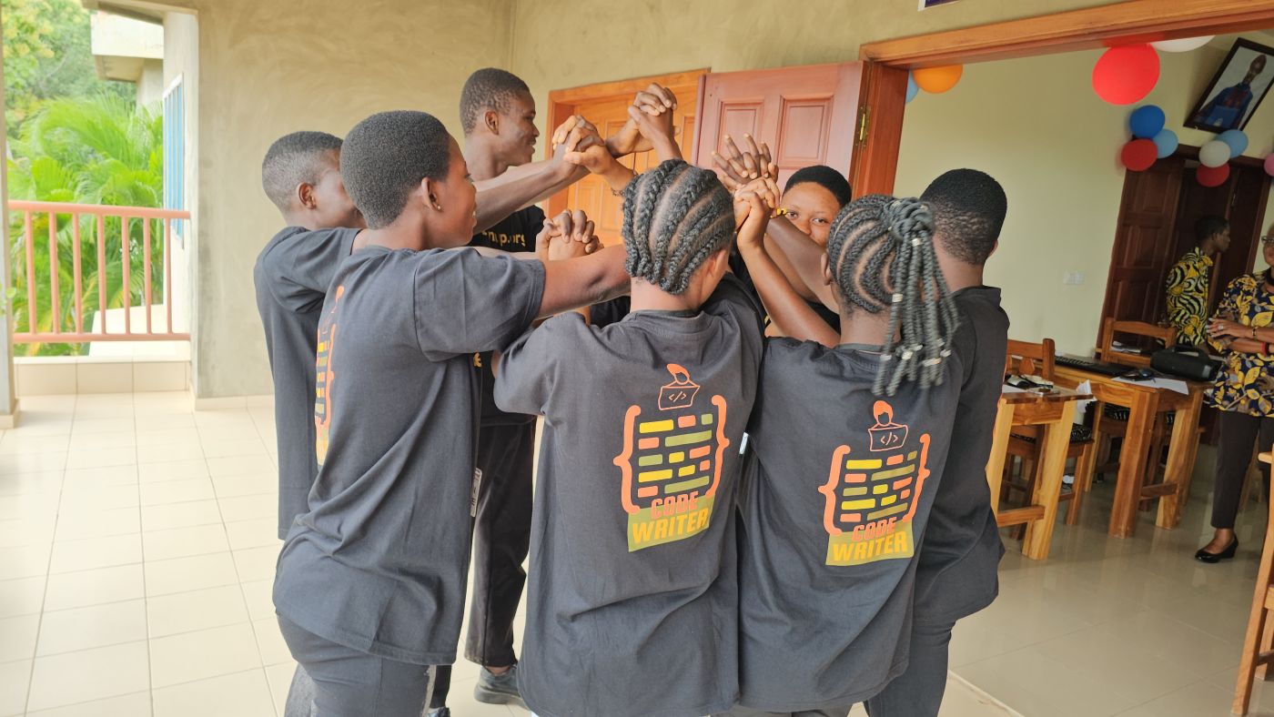 Students, hands joined in a circle