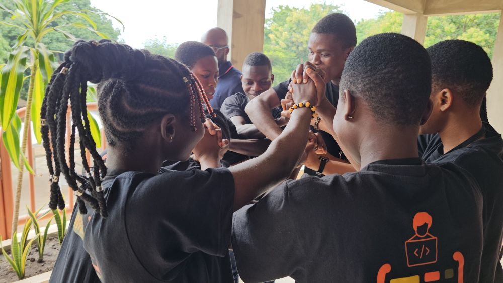 A circle of students, hands joined